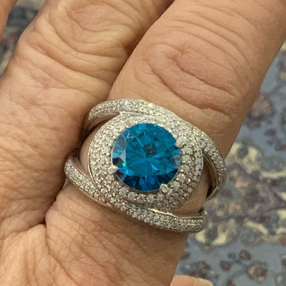 Stunning round Blue Zircon ring swirling with white CZs. Very pretty